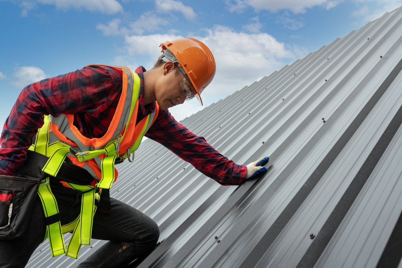 Roofer Installing Metal Sheet